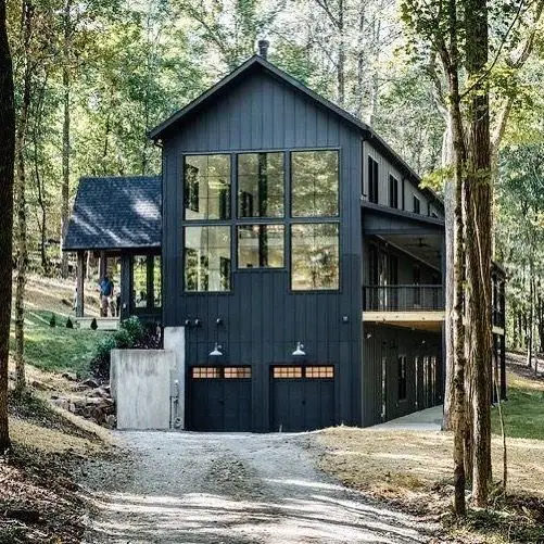 Contemporary And Cozy: A Black Woodland Cabin With Scandinavian Design black modern home